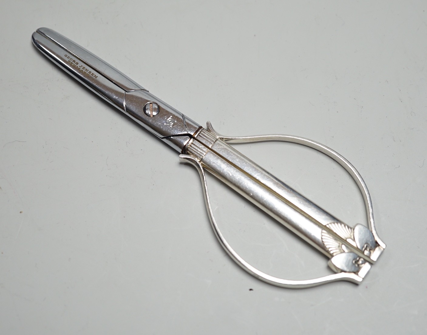 A late 1950's pair of Georg Jensen cactus pattern silver mounted grape shears, 14cm.